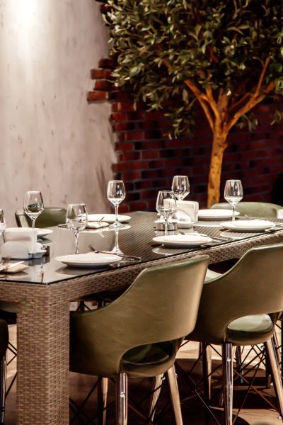 wicker gray table with glass and gray chairs